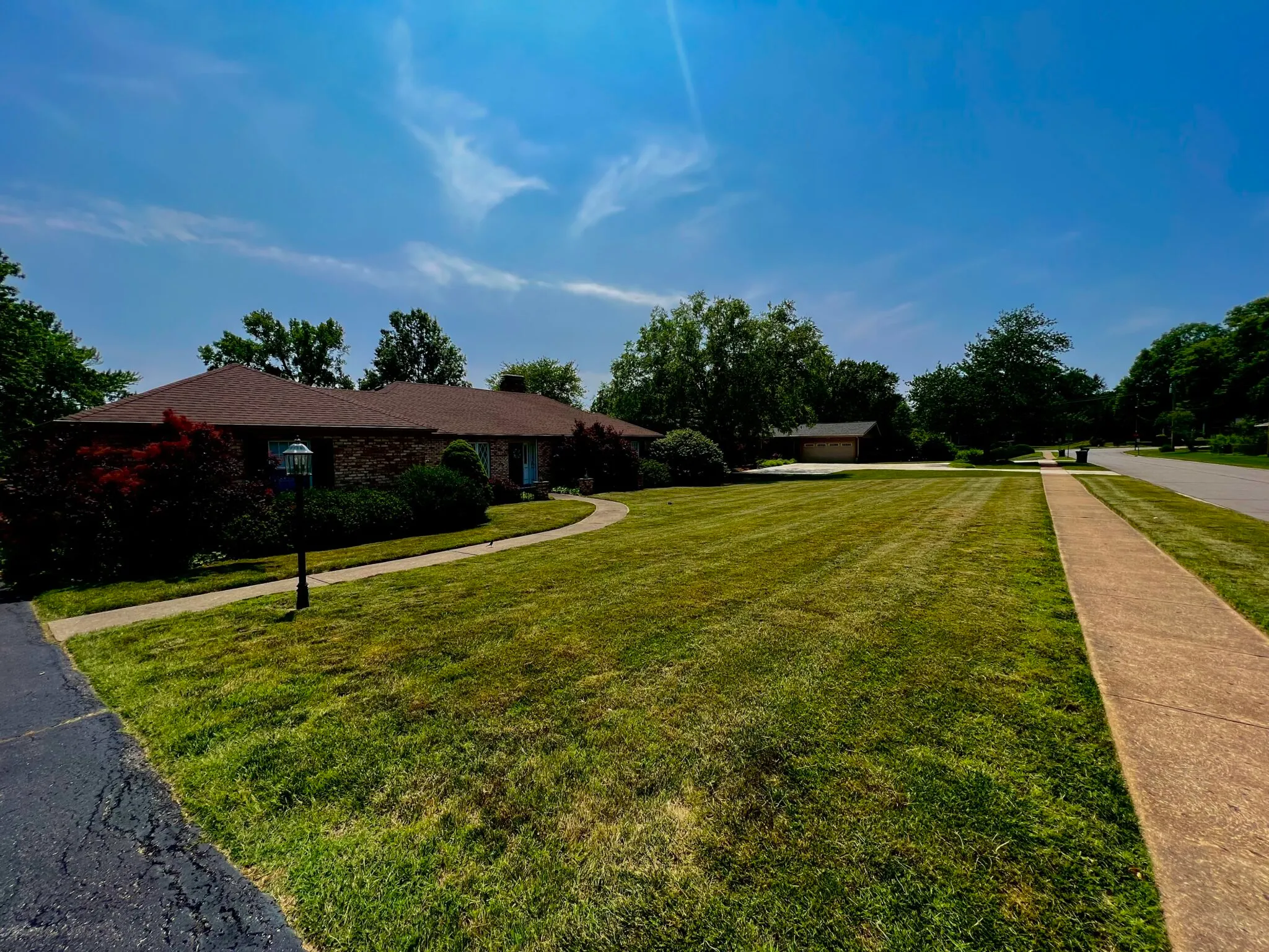 Finished lawn care work beside landscaping